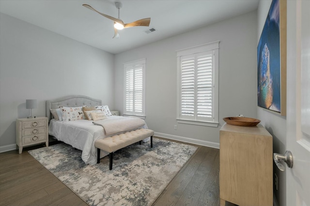 bedroom with ceiling fan and dark hardwood / wood-style flooring