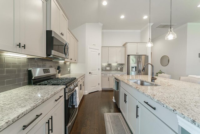 1250 Hammrick Ln, Johns Island, SC 29455 - kitchen with appliances with stainless steel finishes, ornamental molding, backsplash, hanging light fixtures, and light stone counters