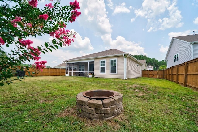 1250 Hammrick Ln, Johns Island, SC 29455 - rear view of house with a sunroom, a fire pit, and a fenced backyard