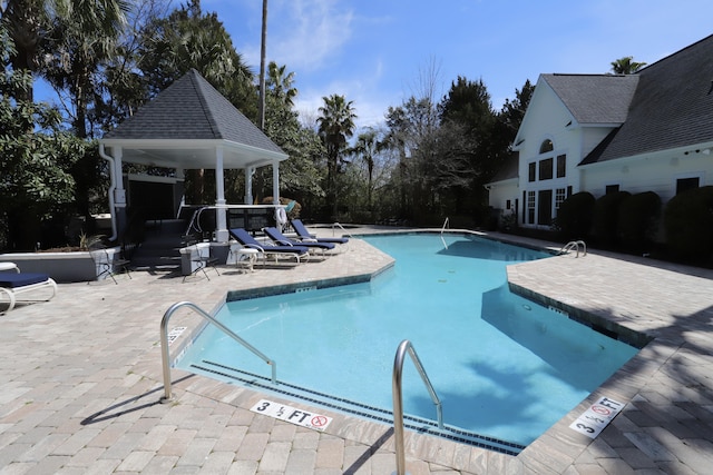 community pool with a patio and a gazebo