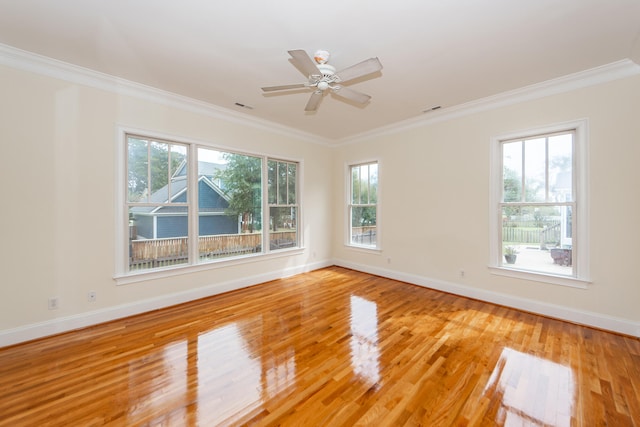 unfurnished room with ceiling fan, light wood-type flooring, crown molding, and a healthy amount of sunlight