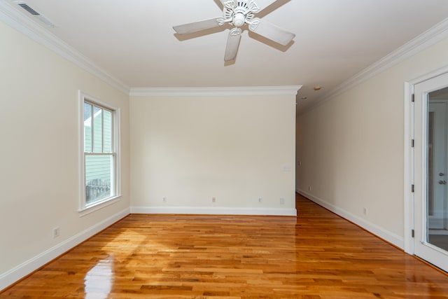 empty room featuring crown molding, light wood-type flooring, and ceiling fan