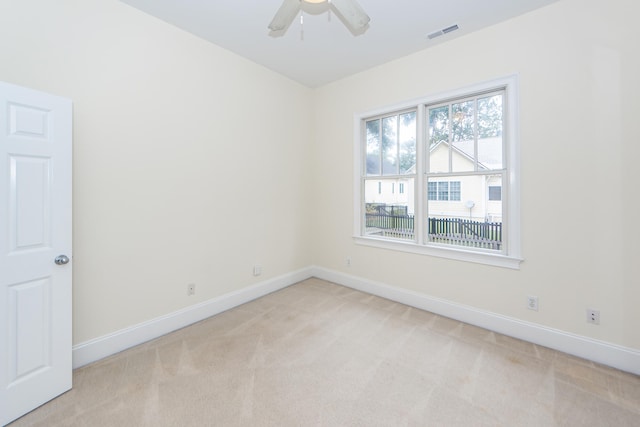 empty room with light colored carpet and ceiling fan