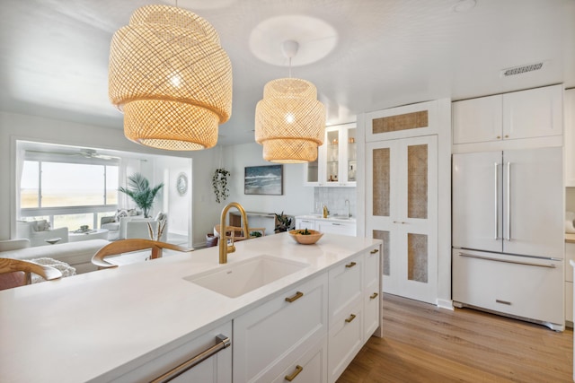 1815 Long Bend Dr, Seabrook Island, SC 29455 - kitchen featuring high end refrigerator, a sink, white cabinetry, and light countertops