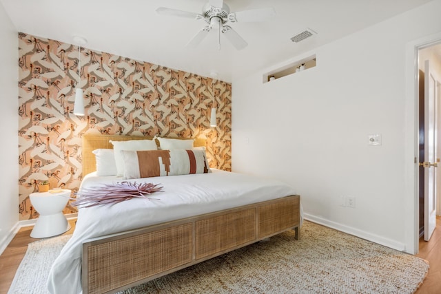 1815 Long Bend Dr, Seabrook Island, SC 29455 - bedroom featuring baseboards, wood finished floors, a ceiling fan, and wallpapered walls