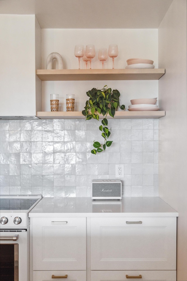 1815 Long Bend Dr, Seabrook Island, SC 29455 - kitchen with white range with electric stovetop, open shelves, decorative backsplash, and white cabinetry