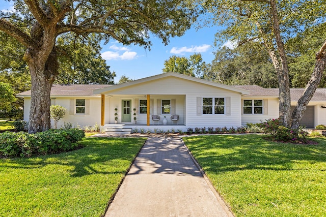 ranch-style house with a garage, a porch, and a front yard