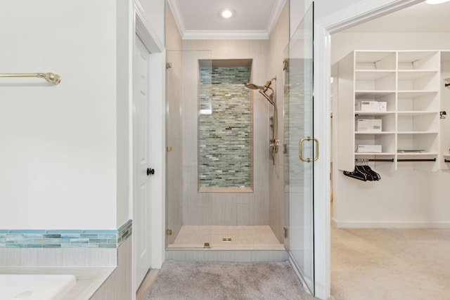 bathroom featuring crown molding and separate shower and tub