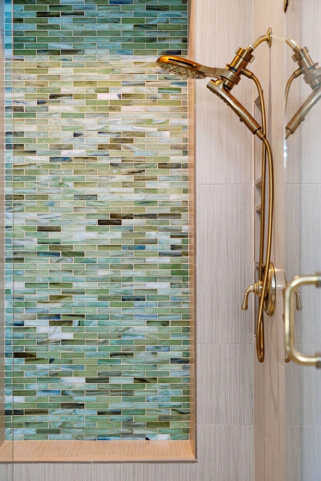 interior details featuring tiled shower