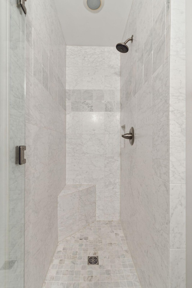 bathroom with a shower with door