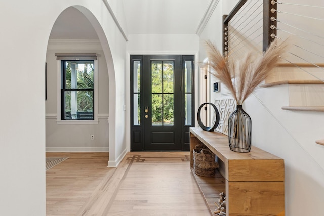 entryway featuring crown molding and light hardwood / wood-style flooring