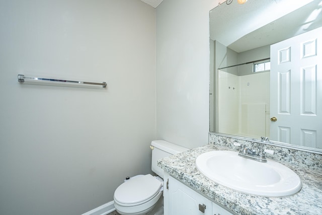 bathroom featuring toilet, vanity, a textured ceiling, and walk in shower