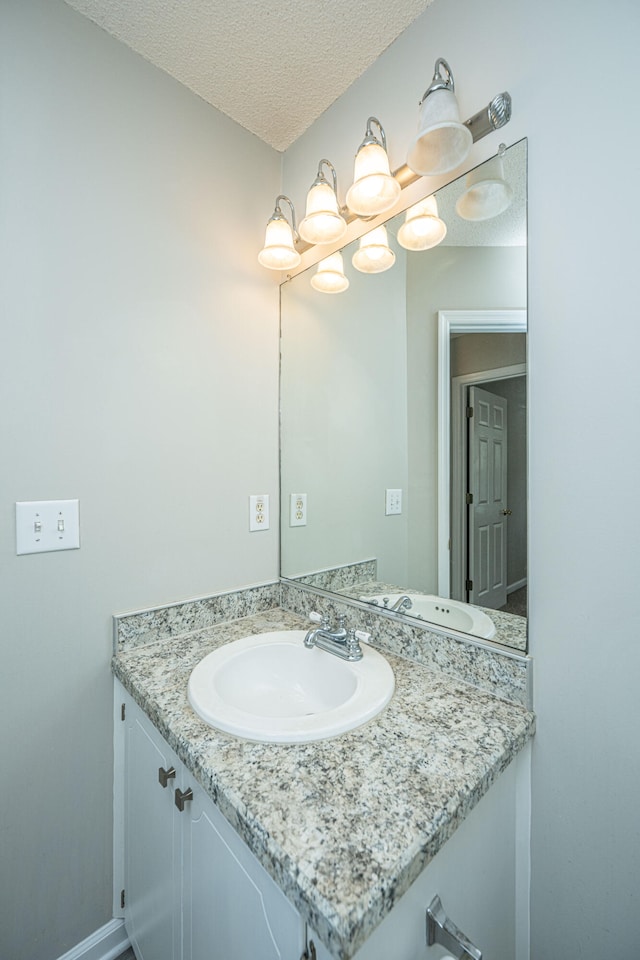 bathroom with vanity and a textured ceiling