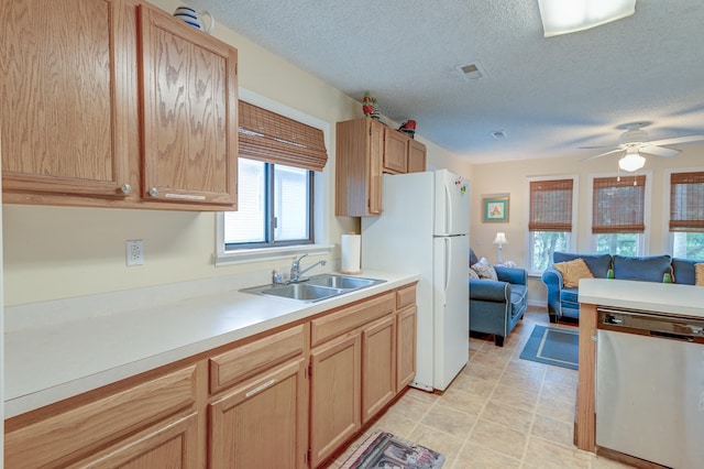 kitchen with white refrigerator, light brown cabinets, sink, dishwasher, and ceiling fan