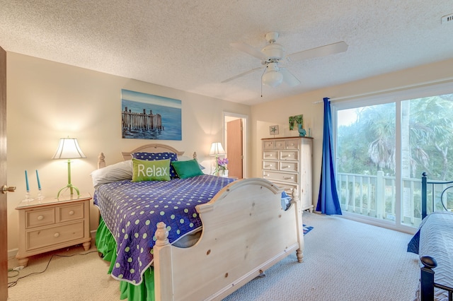 carpeted bedroom with a textured ceiling and ceiling fan