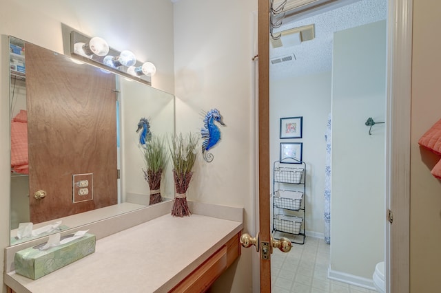 bathroom featuring vanity and a textured ceiling