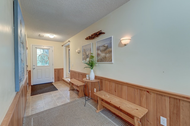 tiled foyer entrance with a textured ceiling