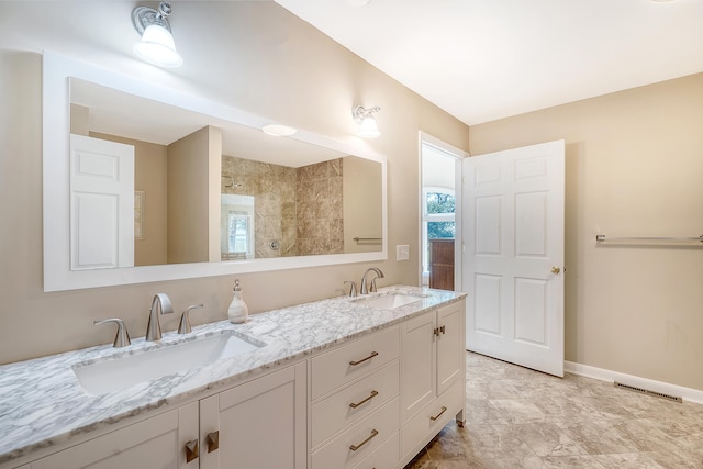 full bath featuring visible vents, a sink, baseboards, and double vanity