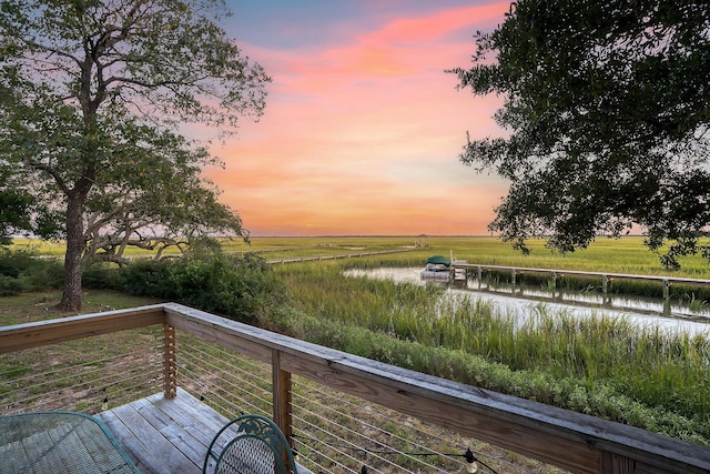 deck with a water view and a rural view