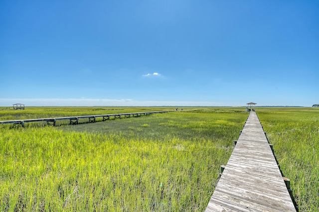 view of dock with a rural view