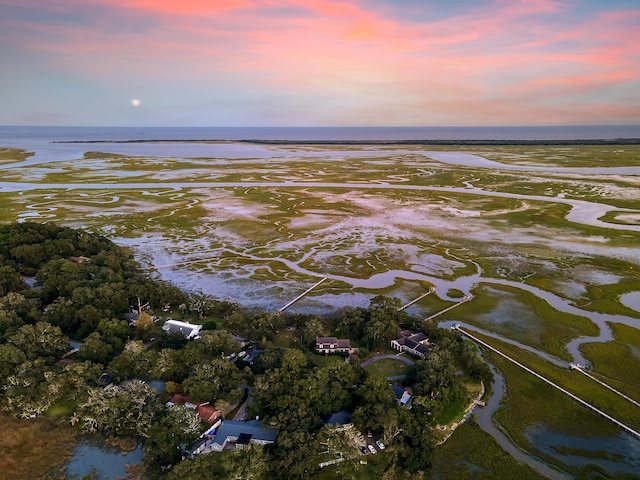 aerial view at dusk with a water view