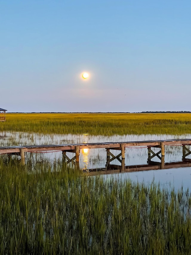 dock area featuring a water view and a rural view