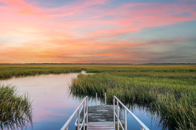 view of dock featuring a water view and a rural view