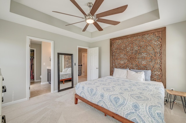 8038 Regency Elm Dr, North Charleston, SC 29406 - bedroom featuring light colored carpet, a tray ceiling, baseboards, ceiling fan, and ensuite bath