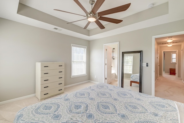 8038 Regency Elm Dr, North Charleston, SC 29406 - bedroom featuring light colored carpet, a raised ceiling, baseboards, ceiling fan, and ensuite bath
