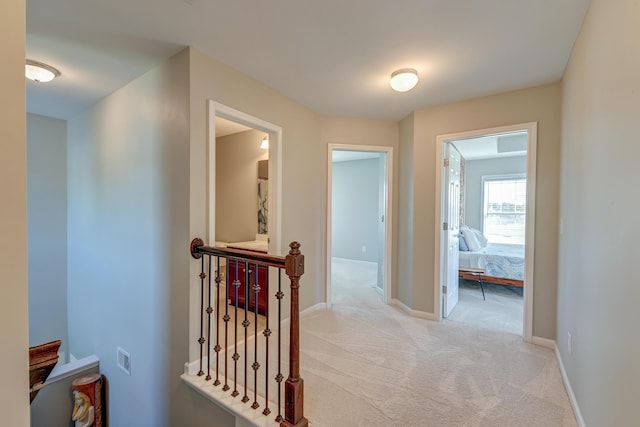 8038 Regency Elm Dr, North Charleston, SC 29406 - corridor with an upstairs landing, light colored carpet, and baseboards