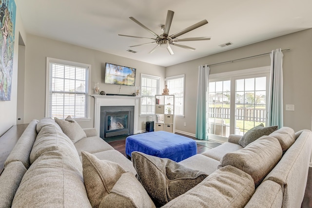 8038 Regency Elm Dr, North Charleston, SC 29406 - living room featuring a fireplace with flush hearth, ceiling fan, wood finished floors, and baseboards
