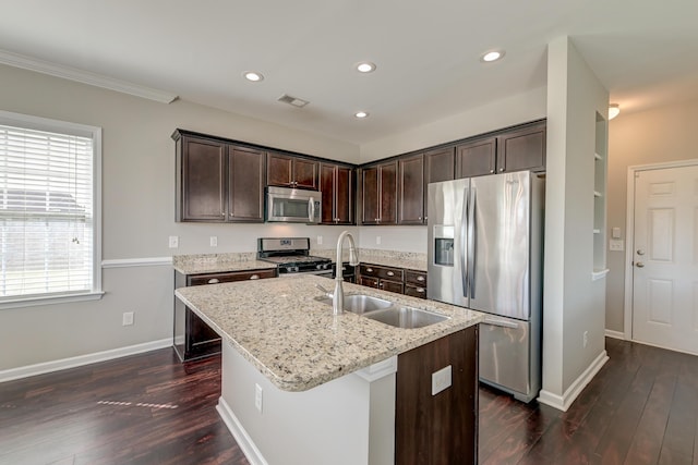 8038 Regency Elm Dr, North Charleston, SC 29406 - kitchen with stainless steel appliances, a sink, dark brown cabinetry, dark wood finished floors, and light stone countertops