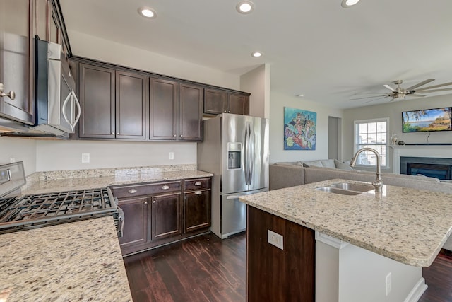 8038 Regency Elm Dr, North Charleston, SC 29406 - kitchen featuring appliances with stainless steel finishes, a sink, open floor plan, dark wood finished floors, and a ceiling fan