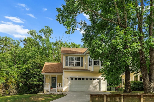 view of front facade featuring an attached garage, covered porch, and driveway