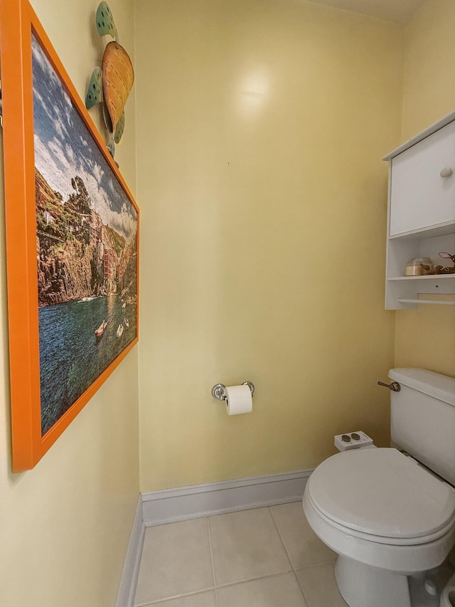 bathroom featuring tile patterned flooring, baseboards, and toilet