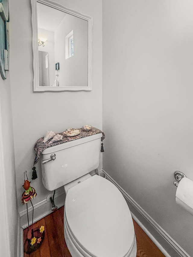 bathroom with baseboards and toilet