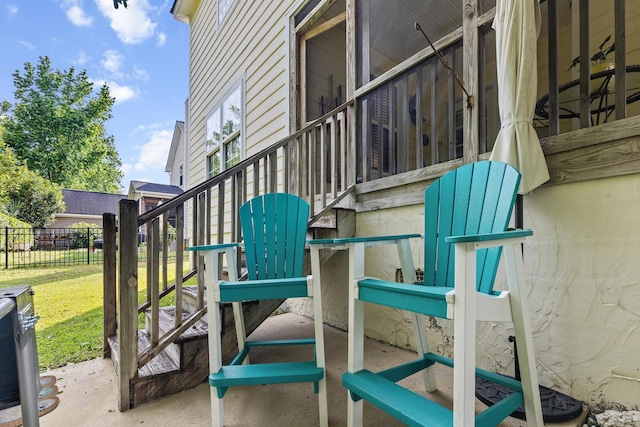 view of patio / terrace featuring stairs and fence