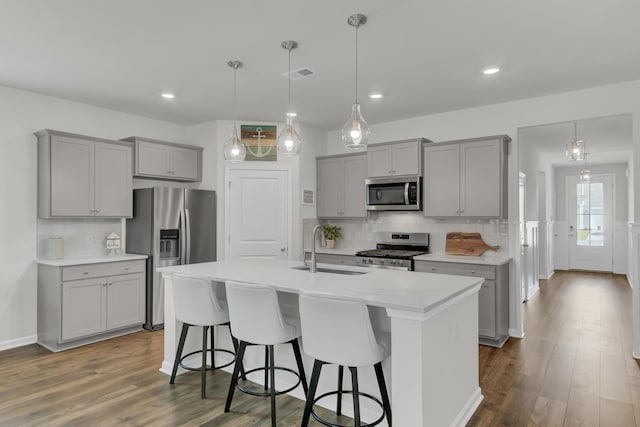 kitchen featuring sink, decorative light fixtures, tasteful backsplash, and appliances with stainless steel finishes