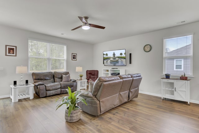 living room featuring ceiling fan and hardwood / wood-style flooring