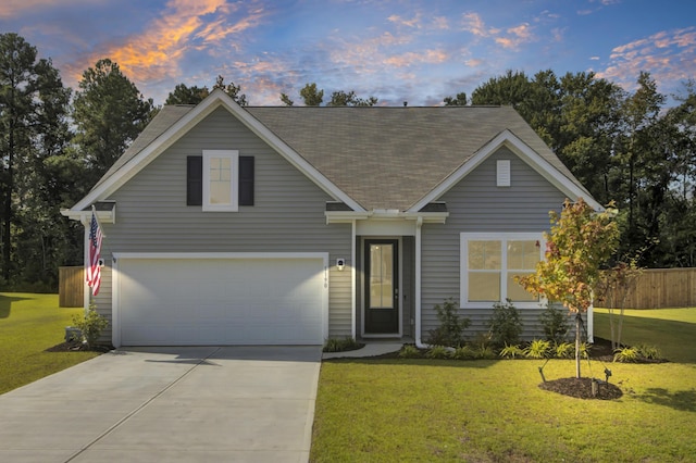 view of front of house featuring a garage and a yard