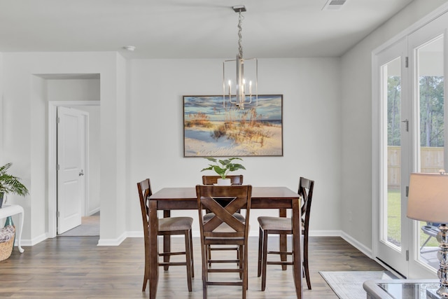 dining space featuring an inviting chandelier and dark hardwood / wood-style floors