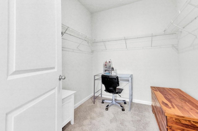 spacious closet featuring light carpet