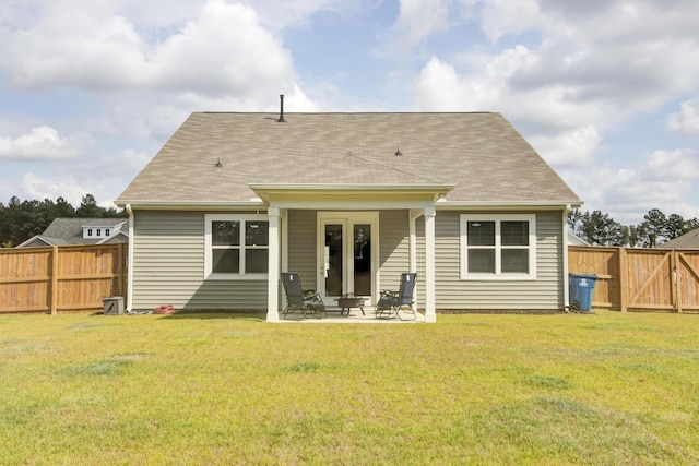 rear view of house with a yard and a patio area