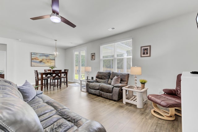 living room with ceiling fan and light hardwood / wood-style floors