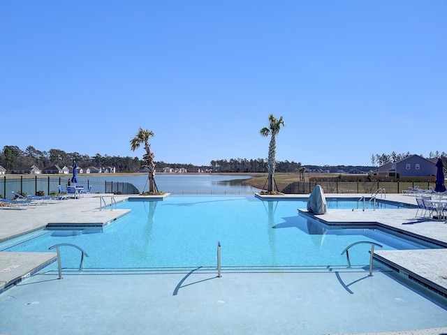 view of swimming pool featuring a water view