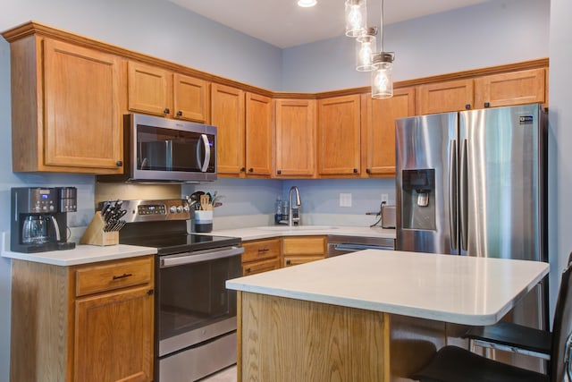 5134 E Liberty Park Cir N, Charleston, SC 29405 - kitchen featuring appliances with stainless steel finishes, a kitchen bar, light countertops, a center island, and decorative light fixtures