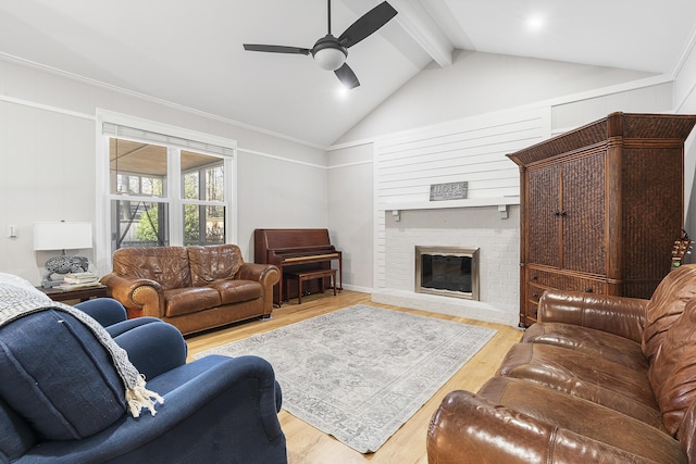 living room featuring a brick fireplace, vaulted ceiling with beams, ceiling fan, and wood finished floors