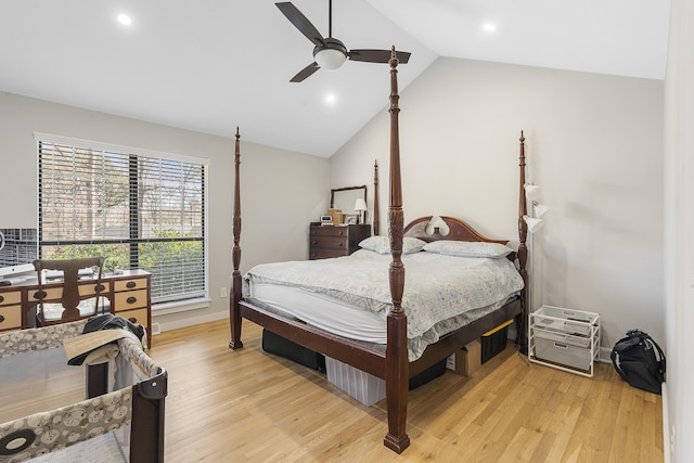 bedroom featuring baseboards, lofted ceiling, light wood-style floors, and a ceiling fan