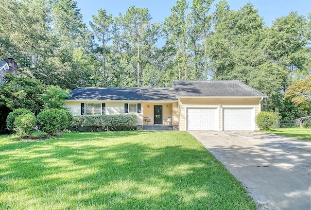 ranch-style home featuring a front lawn, an attached garage, and driveway