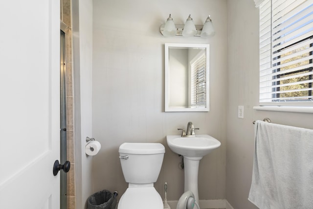 bathroom with an enclosed shower and toilet